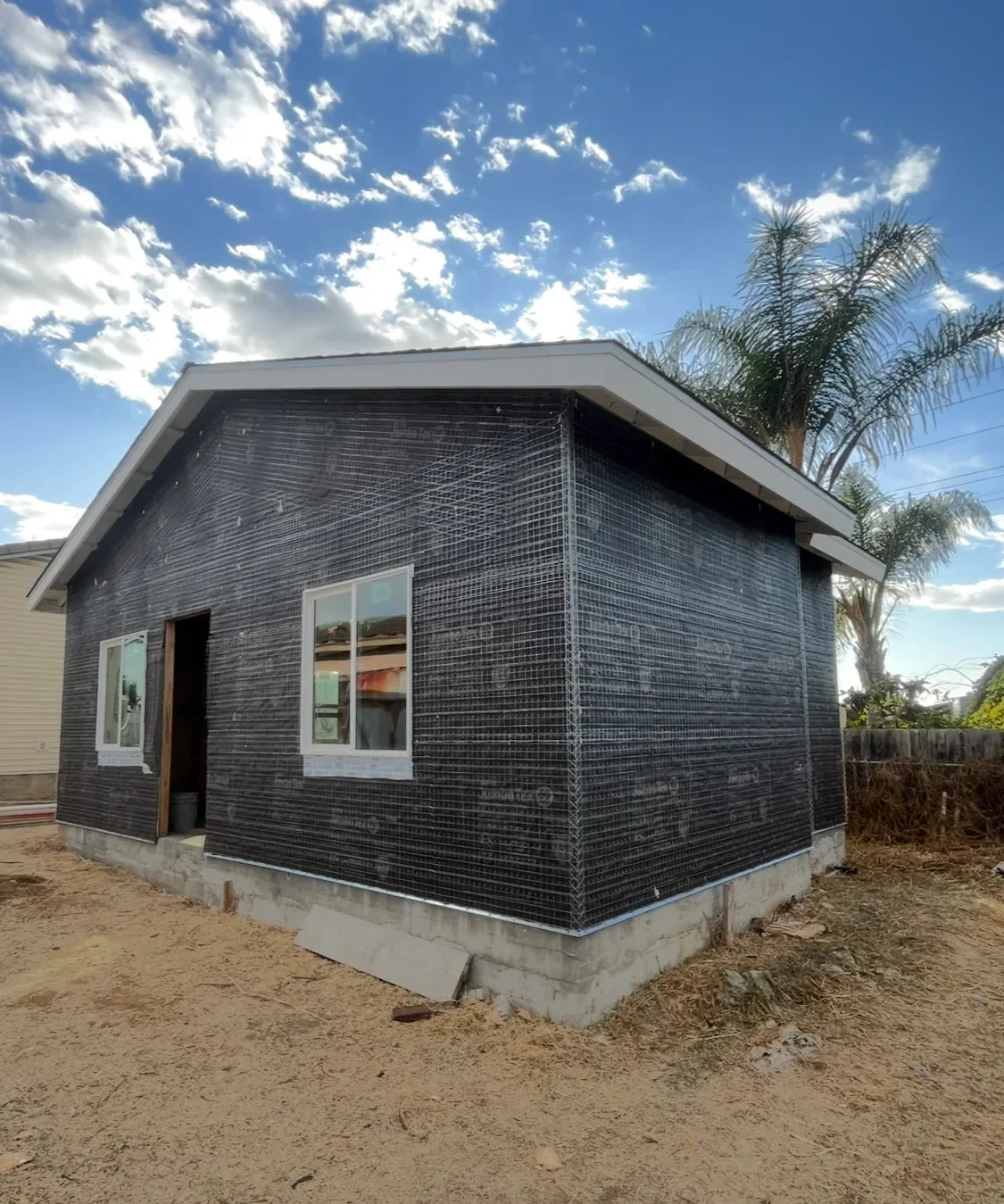 Building exterior during stucco lath installation